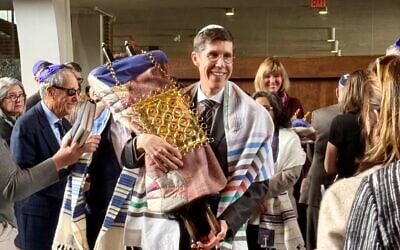 Brett Smiley, mayor of Providence, Rhode Island, carries a Torah scroll at his bar mitzvah held at Temple Beth-El in Providence, March 14, 2026. (Candy Adriance)