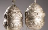 A pair of finials, which adorned the wooden rollers of a Torah scroll, are among the artifacts being returned to Greece. (Jewish Historical Institute in Warsaw)