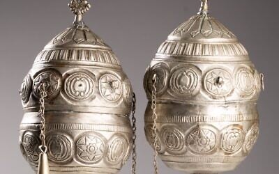 A pair of finials, which adorned the wooden rollers of a Torah scroll, are among the artifacts being returned to Greece. (Jewish Historical Institute in Warsaw)