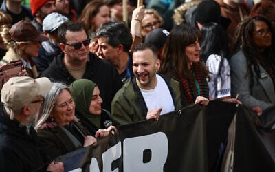Green Party leader Zack Polanski, center, and former Labour party leader Jeremy Corbyn (far left) join protesters holding placards and waving flags as they take part in a march against the far right in central London on March 28, 2026. (Henry Nicholls/AFP) Green Party leader Zack Polanski, center, and former Labour party leader Jeremy Corbyn (far left) join protesters holding placards and waving flags as they take part in a march against the far right in central London on March 28, 2026. (Henry Nicholls/AFP)