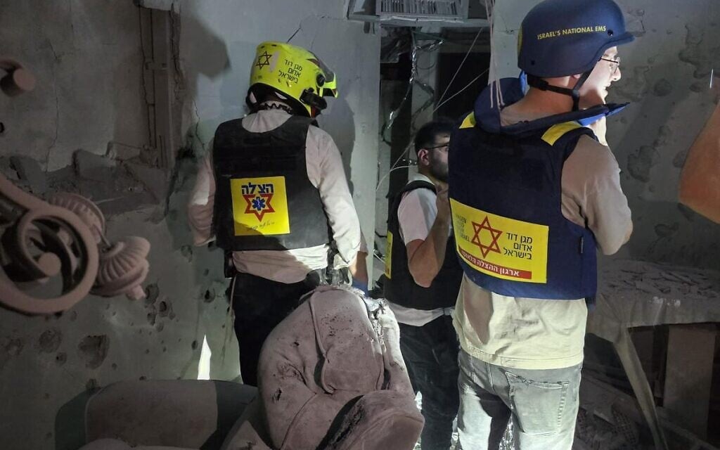 Emergency rescue personnel at a home in Ramat Gan impacted by a deadly Iranian missile attack, early on March 18, 2026 (Magen David Adom)
