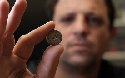 Ilan Hadad from the Israel Antiquities Authority holds a silver shekel coin seized during an inspection at the Hizma Checkpoint north of Jerusalem in the West Bank on February 20, 2026. (Yoli Schwartz/Israel Antiquities Authority) Ilan Hadad from the Israel Antiquities Authority holds a silver shekel coin seized during an inspection at the Hizma Checkpoint north of Jerusalem in the West Bank on February 20, 2026. (Yoli Schwartz/Israel Antiquities Authority)