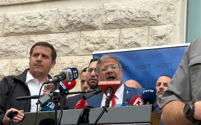 National Security Minister Itamar Ben Gvir speaks to reporters ahead of a hearing on his potential dismissal in the High Court of Justice in Jerusalem on April 15, 2026. (Charlie Summers/Times of Israel)
