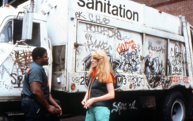 Mierle Laderman Ukeles speaks with a sanitation worker in an archival photo. (Courtesy Toby Perl Freilich via JTA)