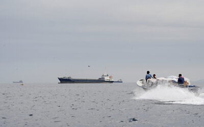 Vessels and a boat at the Strait of Hormuz, off the coast of Oman, April 12, 2026. (Reuters)