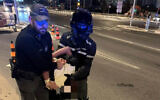 Police arrest a man suspected of disrupting a Memorial Day event in Lod, April 20, 2026. (Israel Police)