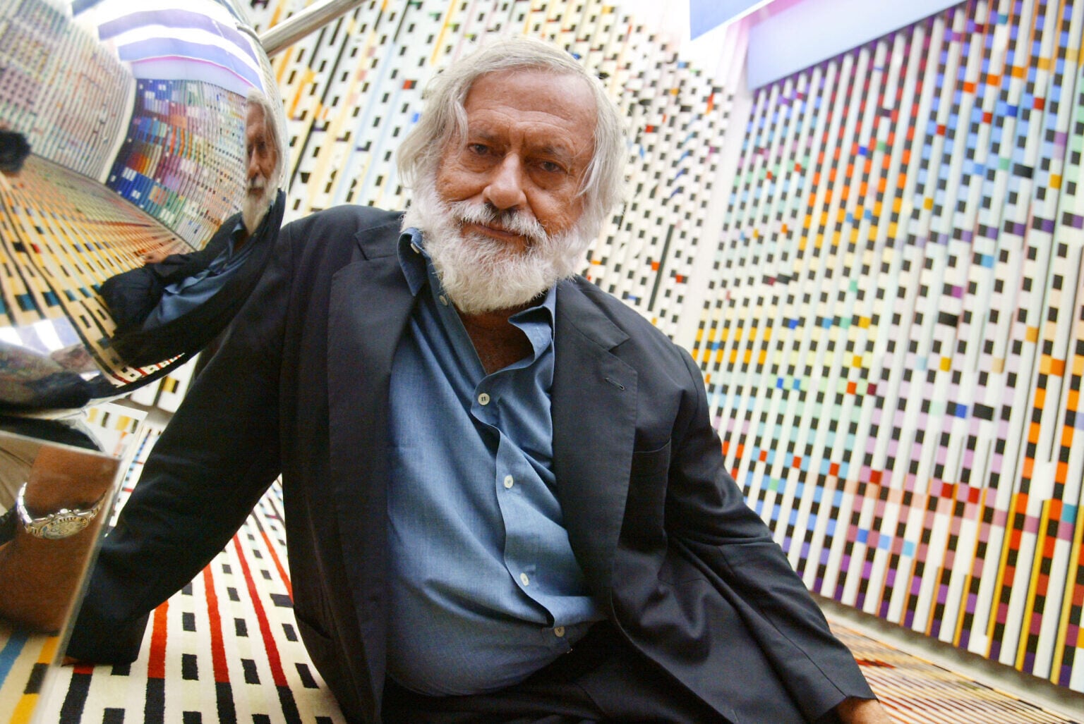 Yaacov Agam, Israeli artist, reclining on one of his works at the Georges Pompidou Art Center, June 28, 2003, in Paris, where his works of kinetic sculpture were on exhibit. (Jack GUEZ / AFP)