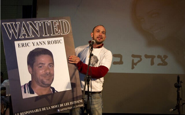 Roy Peled, boyfriend of Lee Zeitouni, 25, who was killed in a hit-and-run accident by French driver Eric Robic two months earlier, holds Robic's picture as he calls for justice during a memorial ceremony in Tel Aviv on December 8, 2011. (Photo by JACK GUEZ / AFP) Roy Peled, boyfriend of Lee Zeitouni, 25, who was killed in a hit-and-run accident by French driver Eric Robic two months earlier, holds Robic's picture as he calls for justice during a memorial ceremony in Tel Aviv on December 8, 2011. (Photo by JACK GUEZ / AFP)