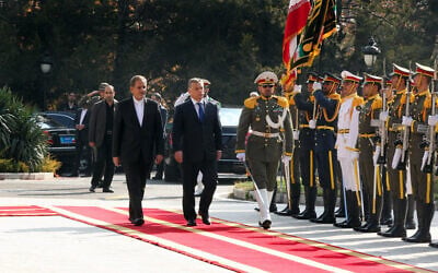 A handout picture provided by the office of Iranian President Hassan Rouhani shows Iran's First Vice President Eshaq Jahangiri (C-L) and Hungarian Prime Minister Viktor Orban (C) review the honour guard upon his arrival in Tehran on November 30, 2015. (AFP/ IRANIAN PRESIDENCY)