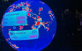 A LED sphere screen shows information inside the new location of the prediction market online platform Polymarket called 'The Situation Room,' during its opening day in Washington, DC, March 20, 2026. (Théo Marie-Courtois/AFP)