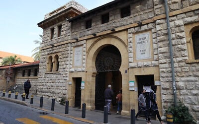 People walk past the main gate to the campus of the American University of Beirut (AUB) in the center of Beirut on January 13, 2022. (ANWAR AMRO / AFP)