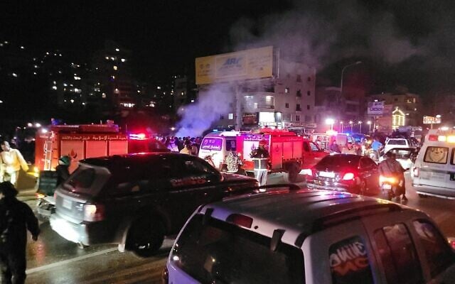First responders rush to the site where a vehicle was targeted in a reported Israeli airstrike in the area of Khalde, south of Beirut, Lebanon, April 1, 2026. (Fadel ITANI / AFP) /
