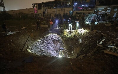 Rescue forces inspect the impact site where an Iranian missile struck in a residential neighborhood of Petah Tikva on April 2, 2026. (Jack Guez/AFP) Rescue forces inspect the impact site where an Iranian missile struck in a residential neighborhood of Petah Tikva on April 2, 2026. (Jack Guez/AFP)