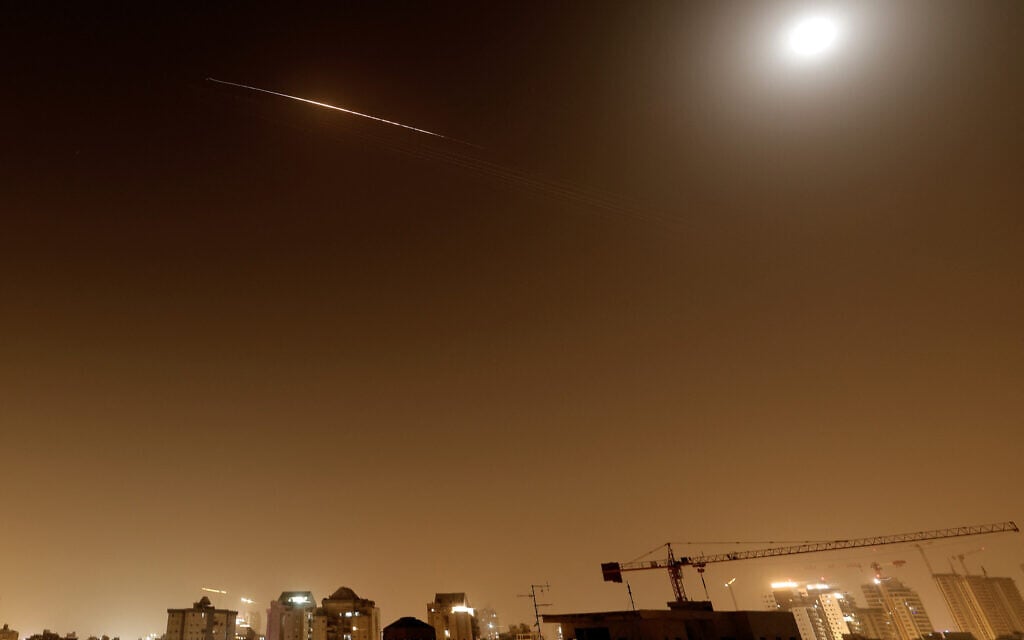Illustrative: Iranian ballistic missile trails are seen in the sky above Netanya, on April 4, 2026. (JACK GUEZ / AFP / File)