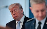 US President Donald Trump looks on as Chairman of the Joint Chiefs of Staff General Dan Caine, right, speaks about the conflict in Iran in the James S. Brady Press Briefing Room of the White House in Washington, April 6, 2026. (Kent Nishimura / AFP)