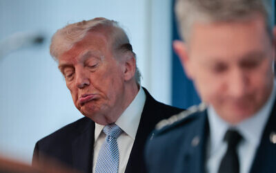 US President Donald Trump looks on as Chairman of the Joint Chiefs of Staff General Dan Caine, right, speaks about the conflict in Iran in the James S. Brady Press Briefing Room of the White House in Washington, April 6, 2026. (Kent Nishimura / AFP)