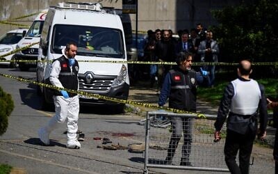 Police officials gather outside the Israeli Consulate in Istanbul, Turkey, on April 7, 2026, following a shootout between gunmen and police. (Yasin AKGUL / AFP)