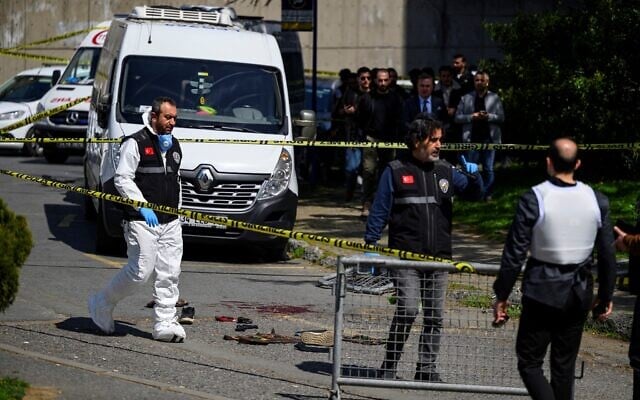 Police officials gather outside the Israeli Consulate in Istanbul, Turkey, on April 7, 2026, following a shootout between gunmen and police. (Yasin AKGUL / AFP)
