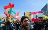 Hezbollah supporters, some waving the Lebanese flag, demonstrate near the Governmental Palace to protest the Lebanese authorities' decision to engage in direct negotiations with Israel to end the ongoing war, in downtown Beirut, April 11, 2026. (Ibrahim Amro/AFP)
