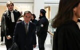 Former CEO of Lafarge Bruno Lafont (C) arrives on the day of the verdict in the trial of the French cement group Lafarge accused of financing terrorism in Syria, at the Paris courthouse, April 13, 2026. (Behrouz MEHRI / AFP)