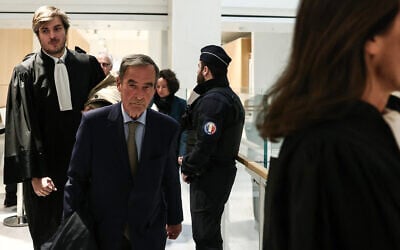Former CEO of Lafarge Bruno Lafont (C) arrives on the day of the verdict in the trial of the French cement group Lafarge accused of financing terrorism in Syria, at the Paris courthouse, April 13, 2026. (Behrouz MEHRI / AFP)