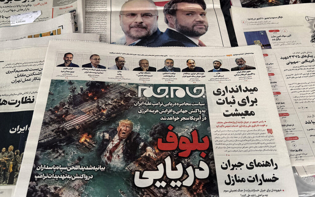 The front page of a newspaper on sale at a Tehran newsstand features a cartoon of US President Donald Trump drowning in the Strait of Hormuz with the headline 'Marine Bluff' on April 13, 2026 (ATTA KENARE / AFP)