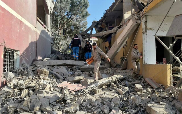 First responders gather at the site of an Israeli airstrike that hit a neighborhood in the southern Lebanese village of Kfar Roummane, on April 13, 2026. (Abbas Fakih/AFP) First responders gather at the site of an Israeli airstrike that hit a neighborhood in the southern Lebanese village of Kfar Roummane, on April 13, 2026. (Abbas Fakih/AFP)