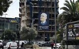 A giant poster of Lebanese Parliament Speaker Nabih Berri, under which reads "Coexistence between Muslims and Christians is a valuable treasure that must be preserved," hangs on a building at the entrance of Beirut's southern suburbs Hadath neighborhood on April 14, 2026. (Joseph EID / AFP)