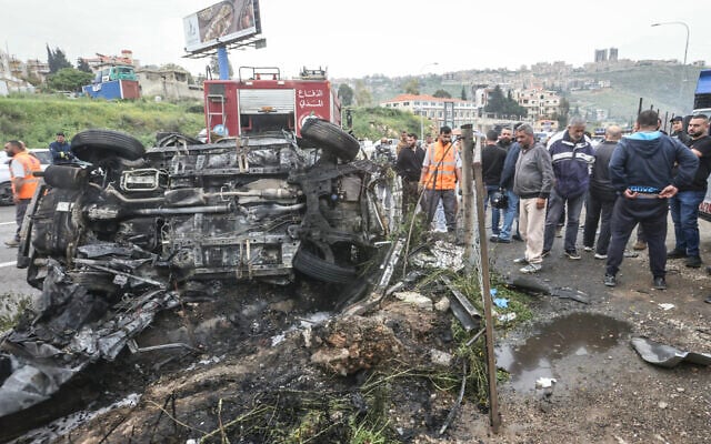 First responders and security forces work at the site of an Israeli airstrike that targeted a vehicle the Lebanese town of Jiyeh, south of Beirut, on April 15, 2026. (Photo by MAHMOUD ZAYYAT / AFP)
