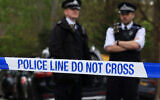 Police officers stand on duty at a cordon near the Finchley Reform Synagogue, in the North Finchley area of north London, on April 15, 2026, following an attack on the synagogue in the early hours of the morning. (Toby Shepheard / AFP)