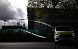 Police tape is pictured in front of satellite dishes inside a warehouse park housing offices of the Iran International television station in Wembley, northwest London on April 16, 2026. (Henry NICHOLLS / AFP)