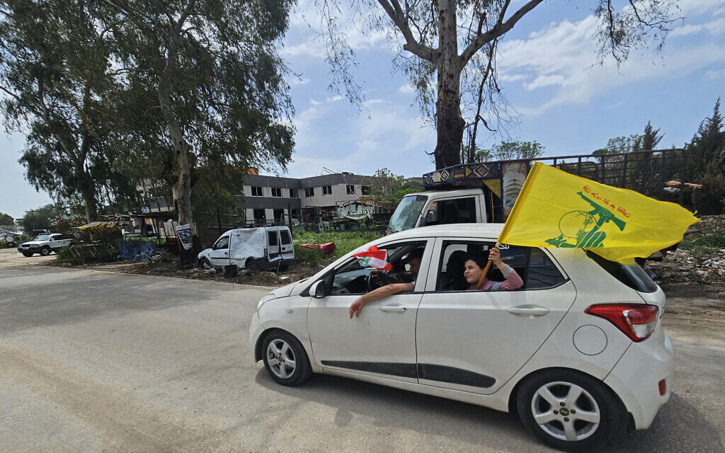 A displaced resident carries a flag of Hezbollah while driving back to his home in the southern Lebanese city of Nabatieh on April 17, 2026. (AFP) A displaced resident carries a flag of Hezbollah while driving back to his home in the southern Lebanese city of Nabatieh on April 17, 2026. (AFP)