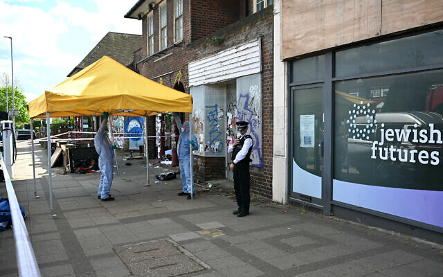 Forensic police officers outside an office formerly used by the Jewish Futures organization in Hendon, northwest London, April 18, 2026. (Justin Tallis / AFP)