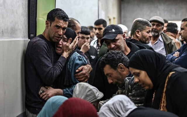 Relatives mourn at a hospital in Ramallah, where their loved ones were taken after being killed by alleged settler gunfire in the village of Al-Mughayyir, east of Ramallah in the West Bank, on April 21, 2026.( Zain Jaafar/AFP)