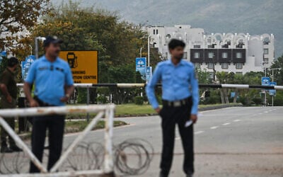 Security personnel stand guard at a checkpoint near the Serena Hotel, which hosted the first round of US-Iran negotiations during the Middle East war, at the Red Zone area in Islamabad on April 21, 2026, amid heightened security measures ahead of the anticipated second round of US-Iran peace talks. (Asif HASSAN / AFP)