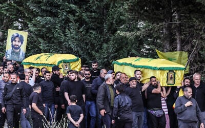 Mourners carry coffins during a mass funeral procession for Hezbollah fighters, killed before a 10-day ceasefire was struck between the Iran-backed terror group and Israel, in the southern village of Kfar Sir on April 21, 2026. (Anwar AMRO / AFP)