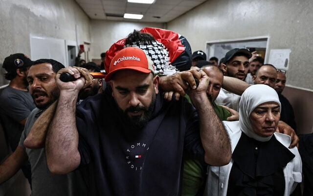 Mourners carry the body Odeh Awawdeh, 29, a Palestinian man who was killed by alleged settler gunfire in the town of Deir Dibwan in the West Bank, at a hospital in Ramallah on April 22, 2026. (Zain JAAFAR / AFP) Mourners carry the body Odeh Awawdeh, 29, a Palestinian man who was killed by alleged settler gunfire in the town of Deir Dibwan in the West Bank, at a hospital in Ramallah on April 22, 2026. (Zain JAAFAR / AFP)
