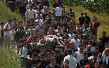 Mourners carry the body of 16-year-old Palestinian Ibrahim Abdel Fattah Al-Khayyat a day after he was killed by IDF gunfire in the southern West Bank city of Hebron on April 30, 2026. (HAZEM BADER / AFP)