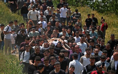 Mourners carry the body of 16-year-old Palestinian Ibrahim Abdel Fattah Al-Khayyat a day after he was killed by IDF gunfire in the southern West Bank city of Hebron on April 30, 2026. (HAZEM BADER / AFP)