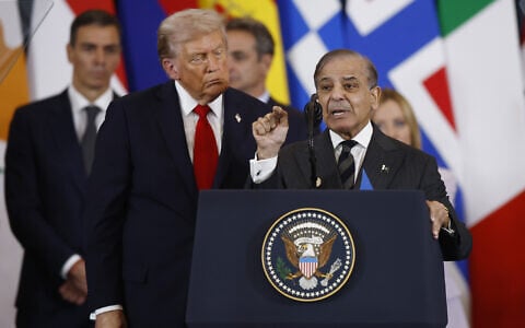 US President Donald Trump watches Pakistan's Prime Minister Shehbaz Sharif delivering a speech at the Gaza International Peace Summit, in Sharm el-Sheikh, Egypt, Monday, Oct.13 2025. (Yoan Valat, Pool photo via AP)