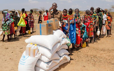 Locals queue to receive food aid as severe drought continues, in Nalemkais Village, Turkana County, Kenya, Feb. 8, 2026. (AP/Patrick Ngugi)