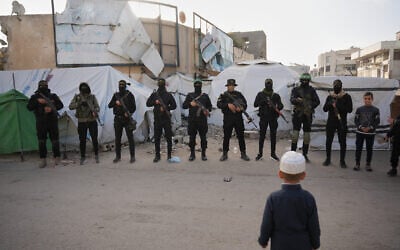 Armed members of Hamas and Islamic Jihad greet people gathering for Eid al-Fitr prayers in Gaza City, March 20, 2026. (AP/Abdel Kareem Hana)
