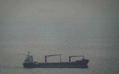 A cargo ship carrying vehicles sails through the Arabian Gulf toward the Strait of Hormuz in the United Arab Emirates, March 22, 2026. (AP Photo)