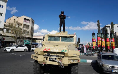 Illustrative: A member of Iran's security forces stands atop an armored vehicle in downtown Tehran on March 30, 2026. (AP Photo/Vahid Salemi) Illustrative: A member of Iran's security forces stands atop an armored vehicle in downtown Tehran on March 30, 2026. (AP Photo/Vahid Salemi)