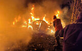 Rescue workers battle flames engulfing vehicles at the site of an Israeli airstrike in Beirut, Lebanon, April 1, 2026. (AP Photo/Hussein Malla)