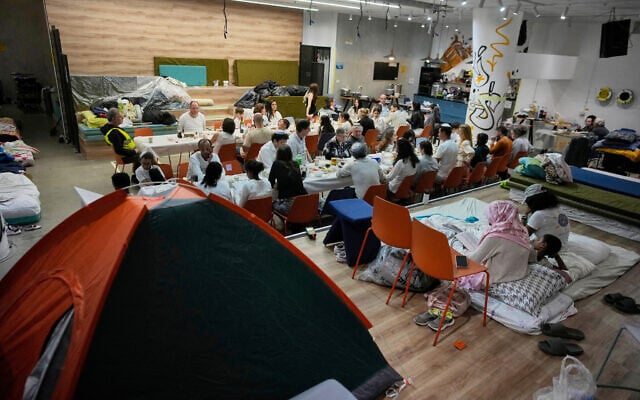 Families celebrate the Passover Seder in an underground shelter, in Ramat Gan, Israel, April 1, 2026. (AP Photo/Ohad Zwigenberg)