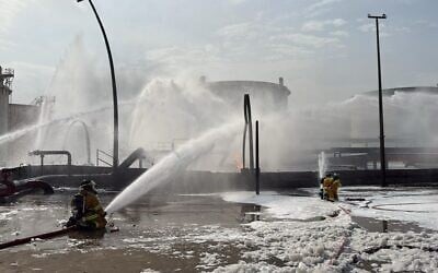 This image released by Bahrain's Interior Ministry shows firefighters extinguishing flames after an Iranian projectile struck an industrial area in Ma'ameer, Bahrain, March 9, 2026. (Bahrain Interior Ministry via AP, File)