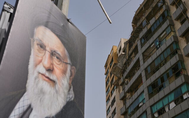 A portrait of Iran's late supreme leader Ayatollah Ali Khamenei is seen near a building damaged in an Israeli airstrike in Dahiyeh, Beirut's southern suburbs, Lebanon, Saturday, April 4, 2026. (AP Photo/Bilal Hussein)