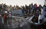 Palestinians inspect a vehicle struck by an Israeli airstrike in the Maghazi refugee camp in the central Gaza Strip, April 4, 2026. (Kareem Hana/AP)