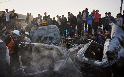 Palestinians inspect a vehicle struck by an Israeli airstrike in the Maghazi refugee camp in the central Gaza Strip, April 4, 2026. (Kareem Hana/AP)